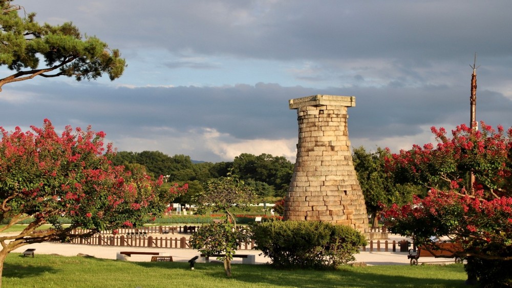 Cheomseongdae Observatory Tower surrounded by blooming trees, Gyeongju